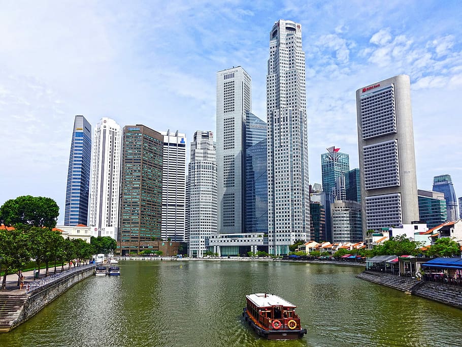 photo of white and red boat on river near on high rise building HD wallpaper