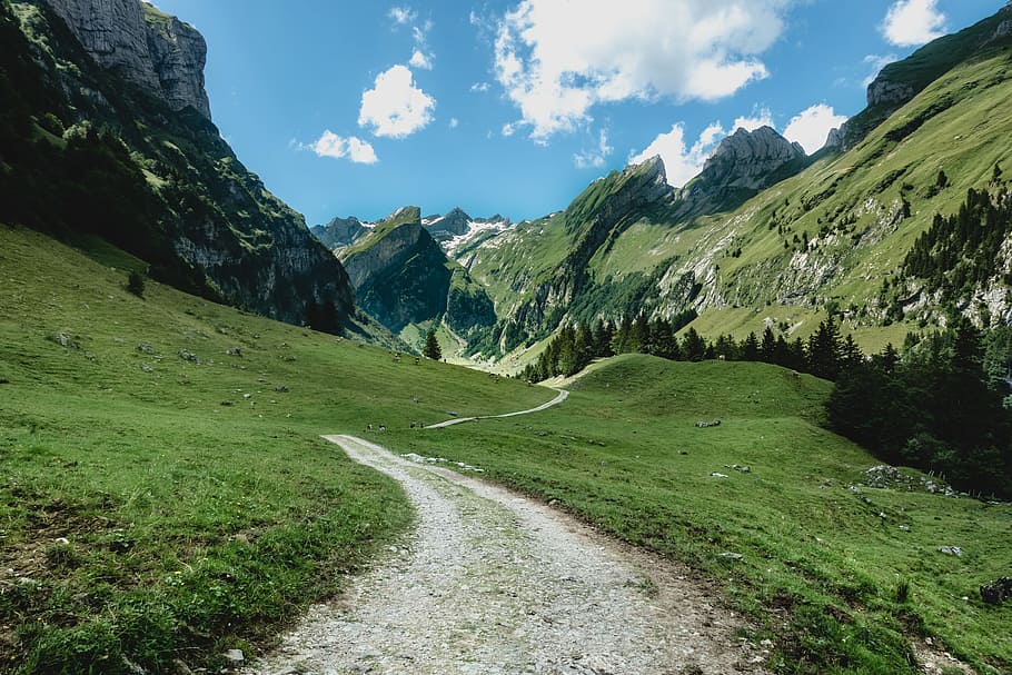 green mountain during white cloudy skies, gray pathway on grass field HD wallpaper