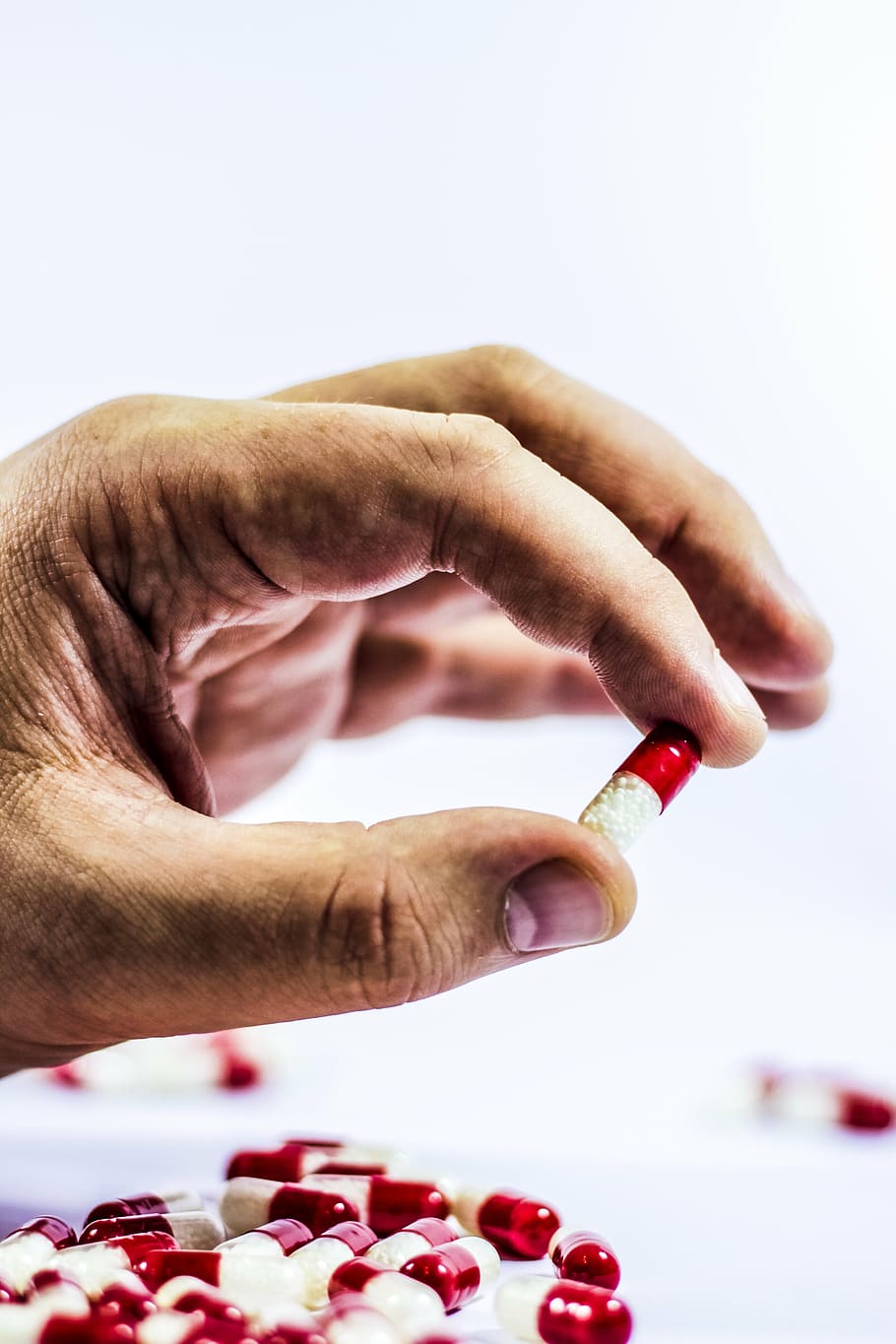 person holding red and white medication capsule, cure, drug HD wallpaper