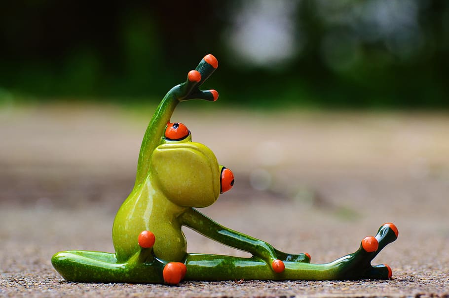 green ceramic frog holding knee during daytime, sport, gymnastics