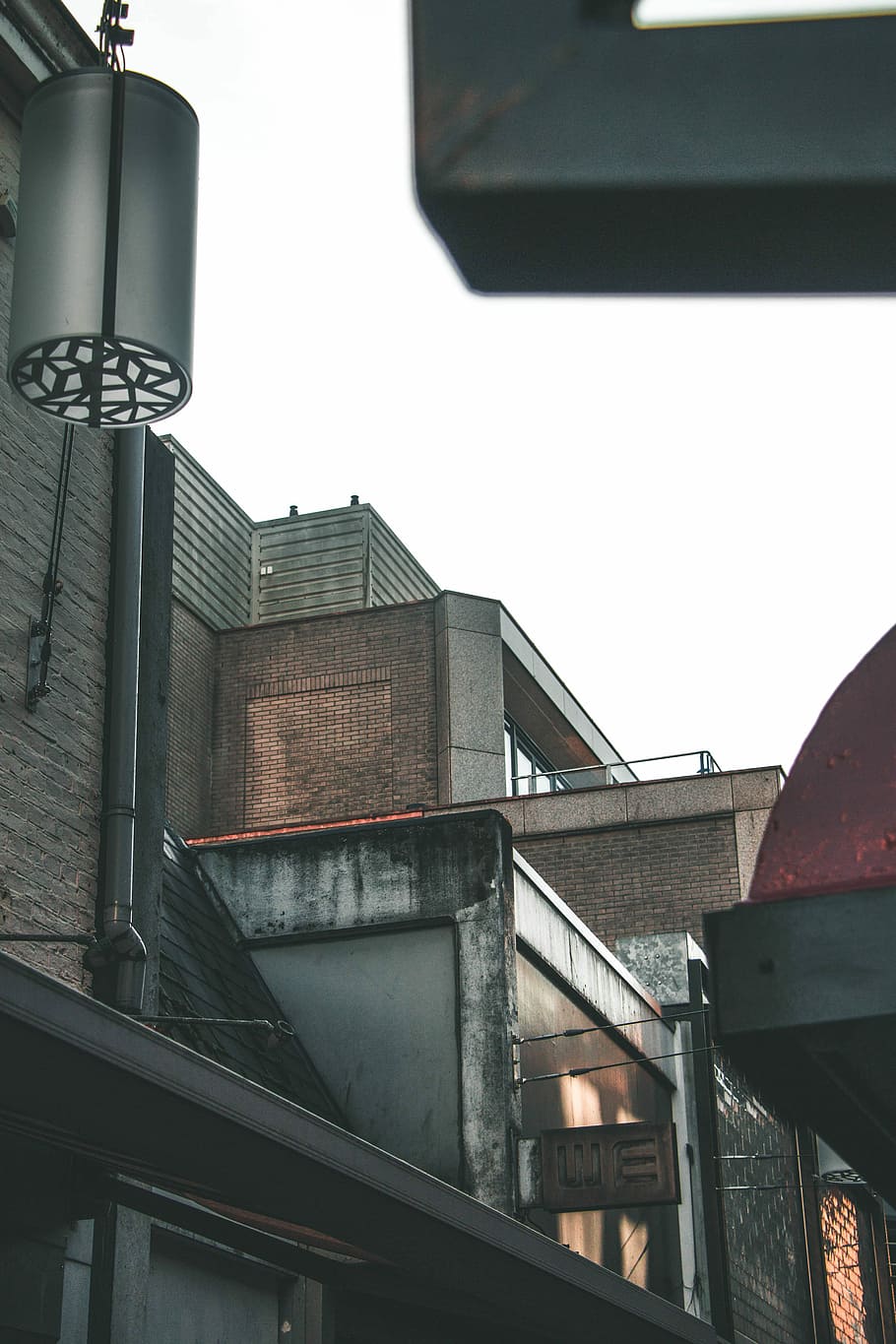 low angle photo of gray concrete buildings, brown brick building HD wallpaper