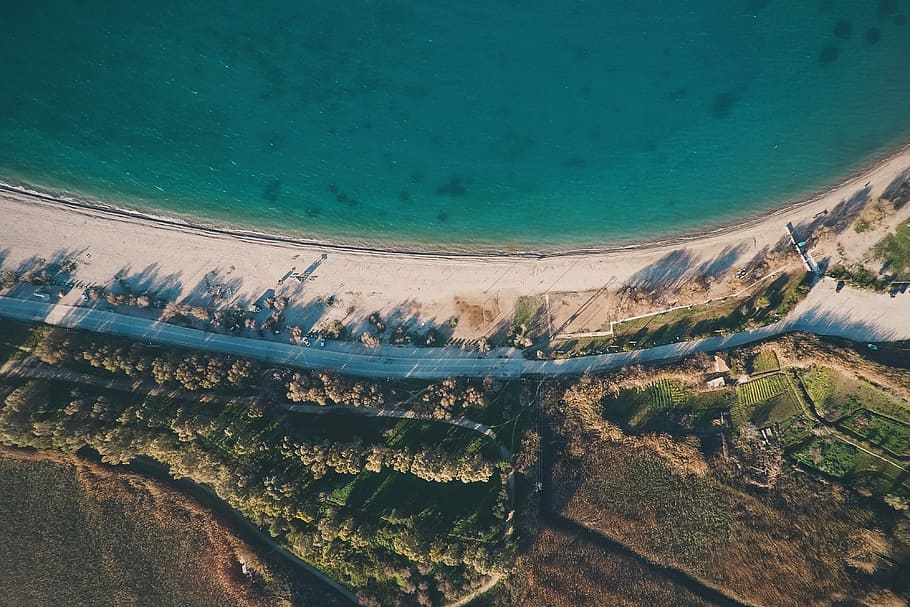 aerial photography of sea and green trees, aerial photography of road beside body of water HD wallpaper