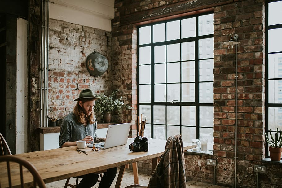 Sponsored by Google Chromebooks, man uses laptop on brown wooden tble HD wallpaper