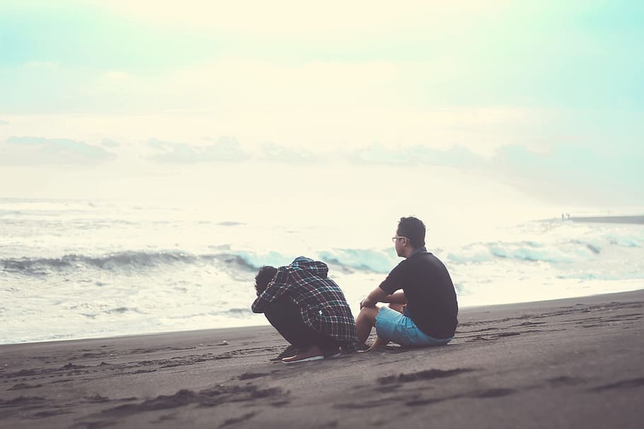 Two Man Sitting on the Sand Near the Beach, adults, bright, cloudy sky HD wallpaper