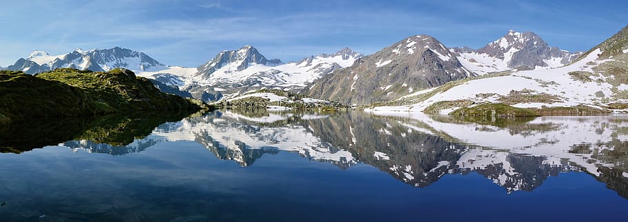 gray mountains across body of water under blue sky at daytime HD wallpaper
