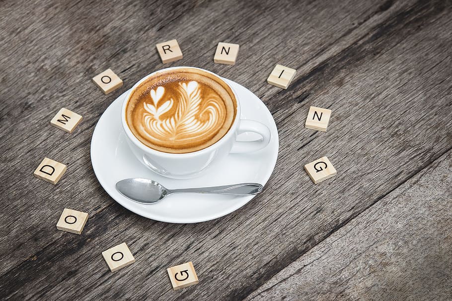 a cup of cappuccino with flower art and with scrabble letter words good morning greeting HD wallpaper