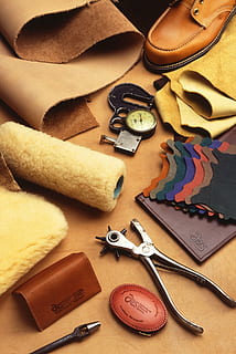 bullet hole puncher beside mat, watch, and wallet, leathercraft HD wallpaper