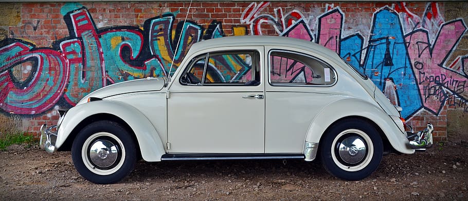 white Volkswagen Beetle parked beside wall, vw, graffiti, classic