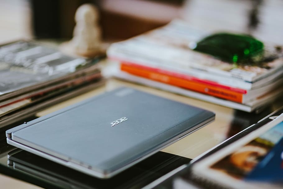 Laptop, a smartphone, magazines and cups of coffee on a table HD wallpaper