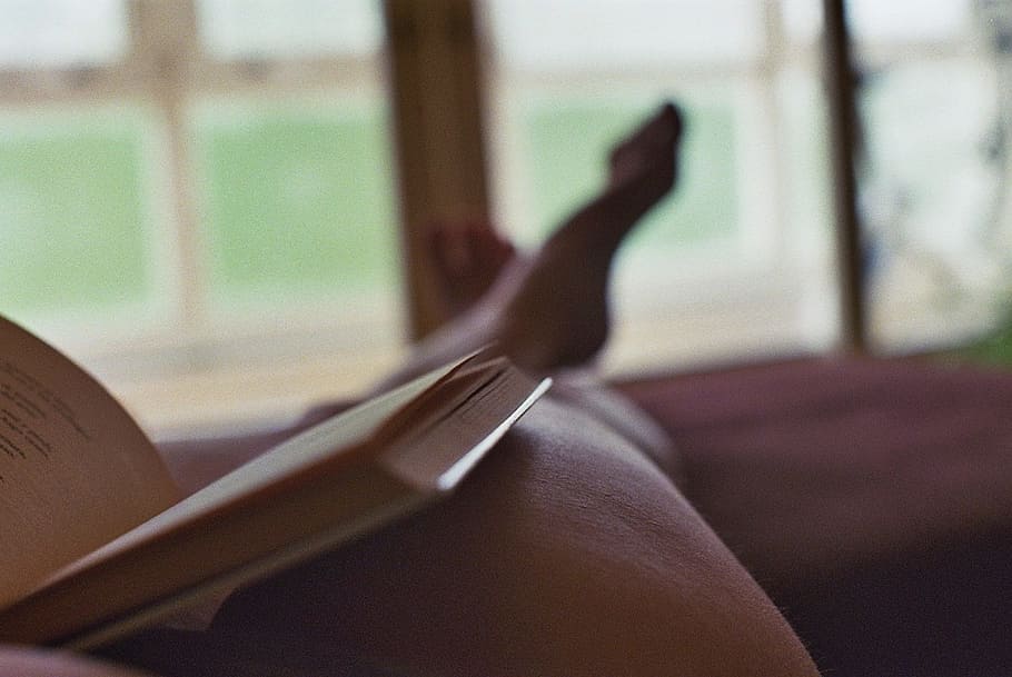 brown book on person leg, reading, legs, human body part, one person HD wallpaper