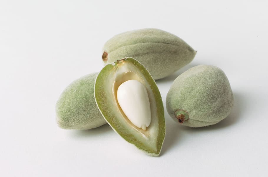 pile of four oblong green fruits, almonds, hulls, nut, seed HD wallpaper