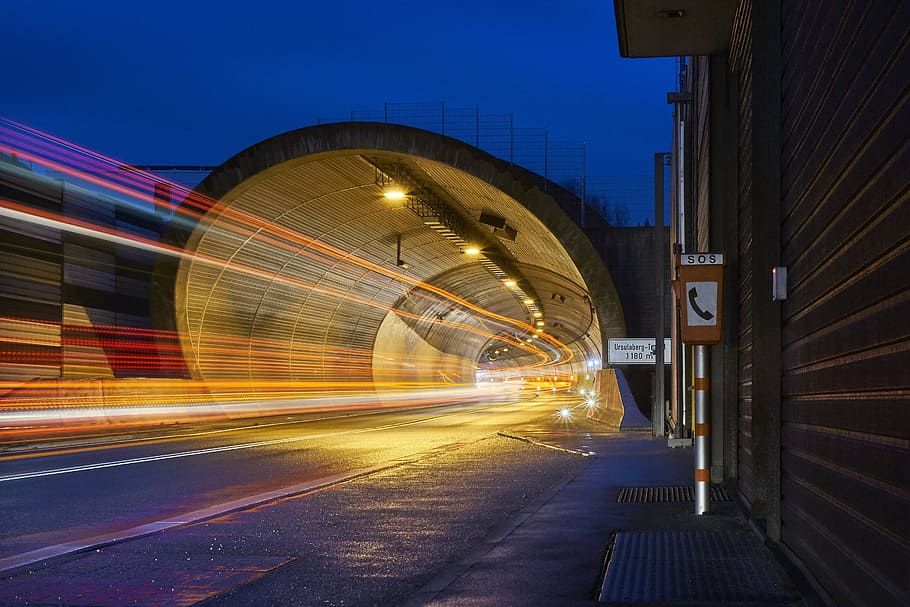 timelapse photography of speeding lights under road tunnel during nighttime HD wallpaper