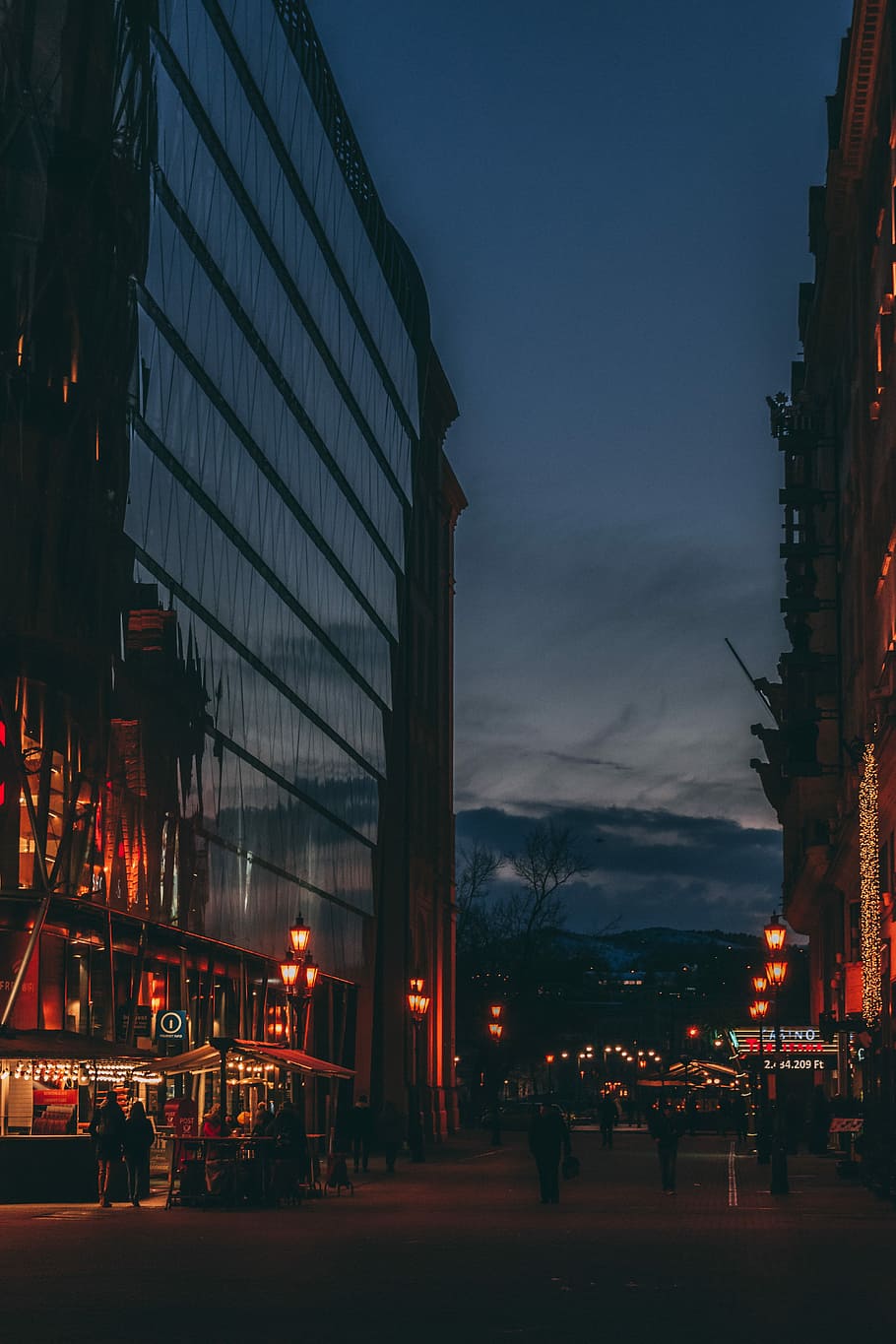 people standing near building, high rise building during night time HD wallpaper
