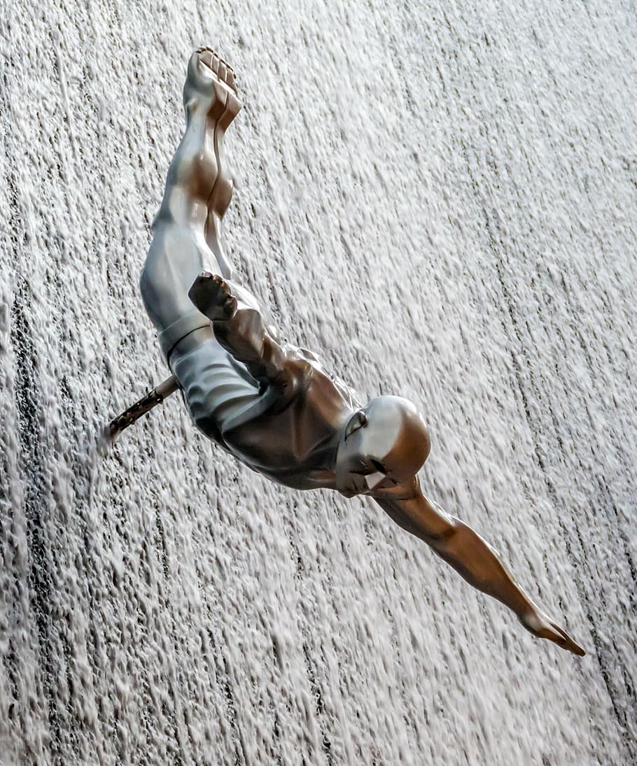 brass figure of man on wall, springer, high diver, jump, high diving