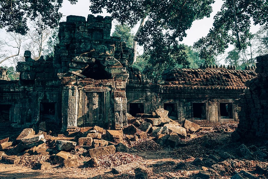 grey abandoned concrete house near trees at daytime, angkor, antique