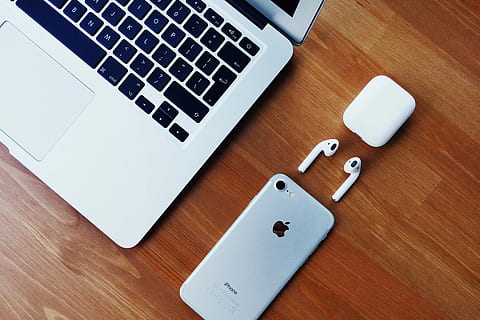silver iPhone 6 on the brown wood, silver iPhone 7, AirPods, and MacBook Air HD wallpaper