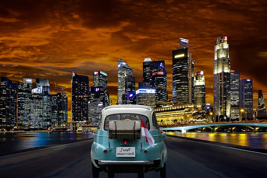 classic teal car near lighted high rise building during nighttime, HD wallpaper