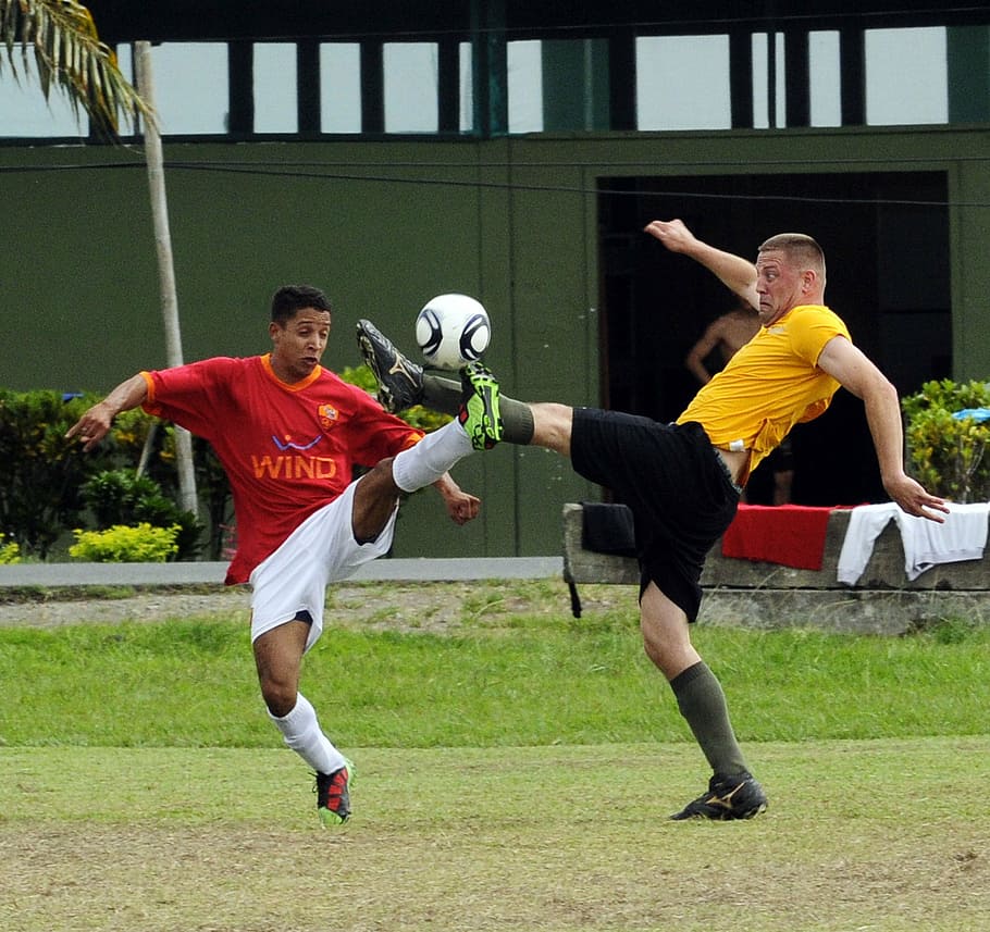 two men playing soccer during daytime, tumaco, columbia, football