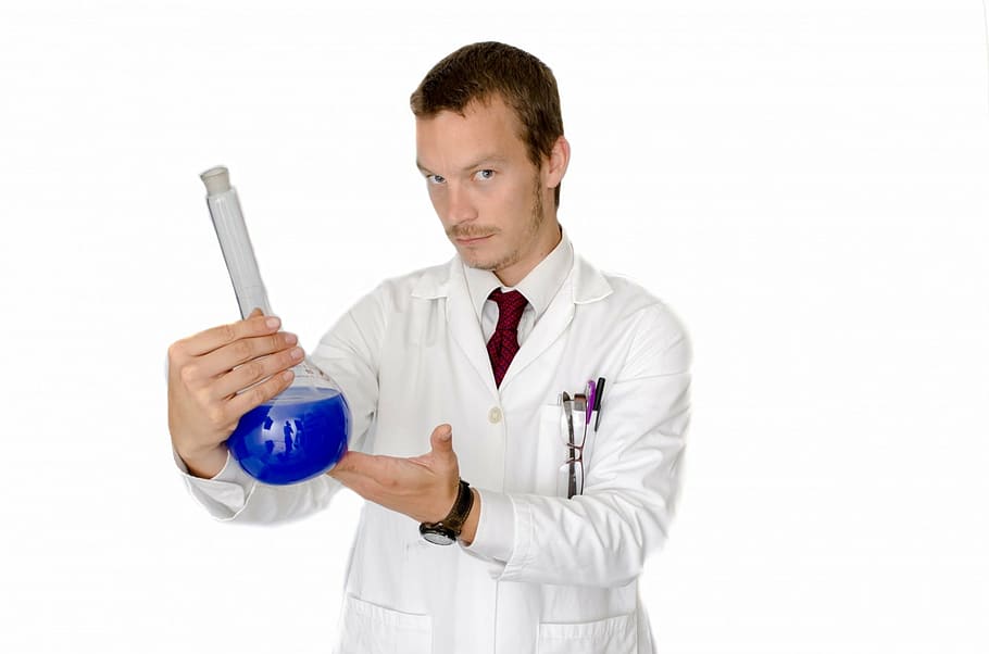 man wearing laboratory robe while holding clear glass container