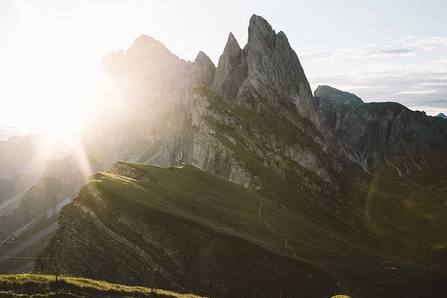 sunrise behind the mountain, grey rocky mountain with shining light HD wallpaper