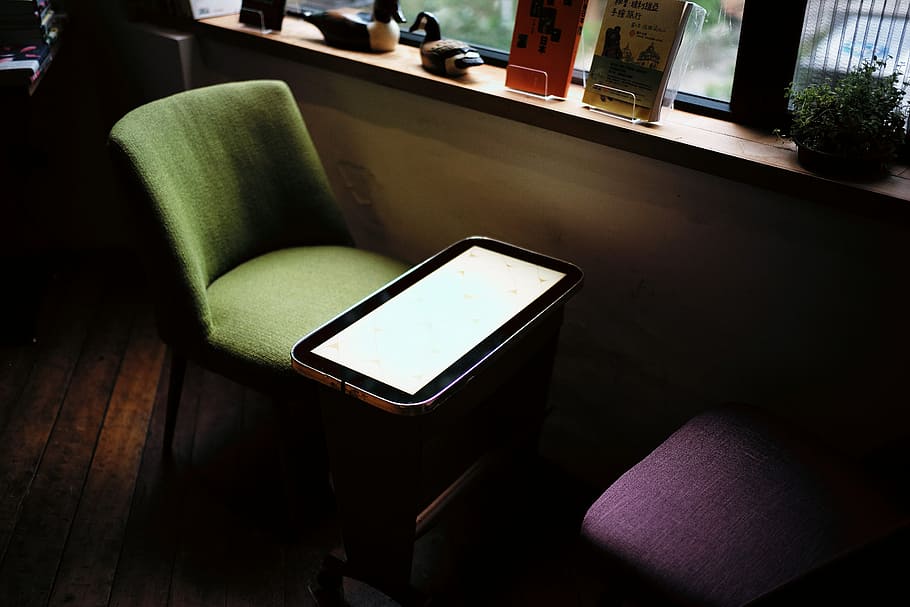 green chair in front of table near window, smartphone on sofa HD wallpaper