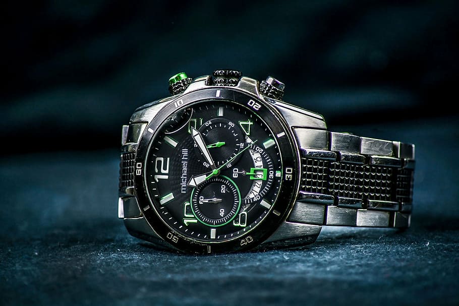 round black, green, and white chronograph watch displaying 11:10