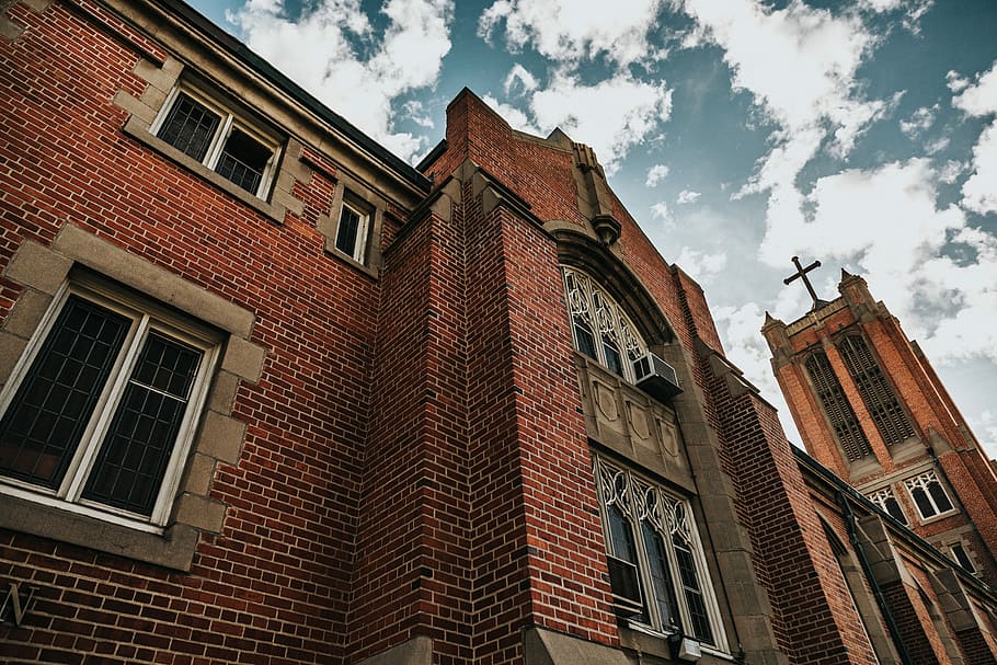 brown brick building, low-angle photography of brown cathedral HD wallpaper