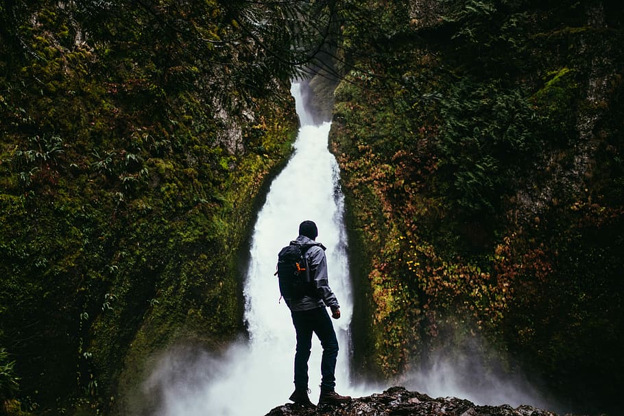 man standing on cliff infront of waterfalls, guy, hiker, hiking HD wallpaper