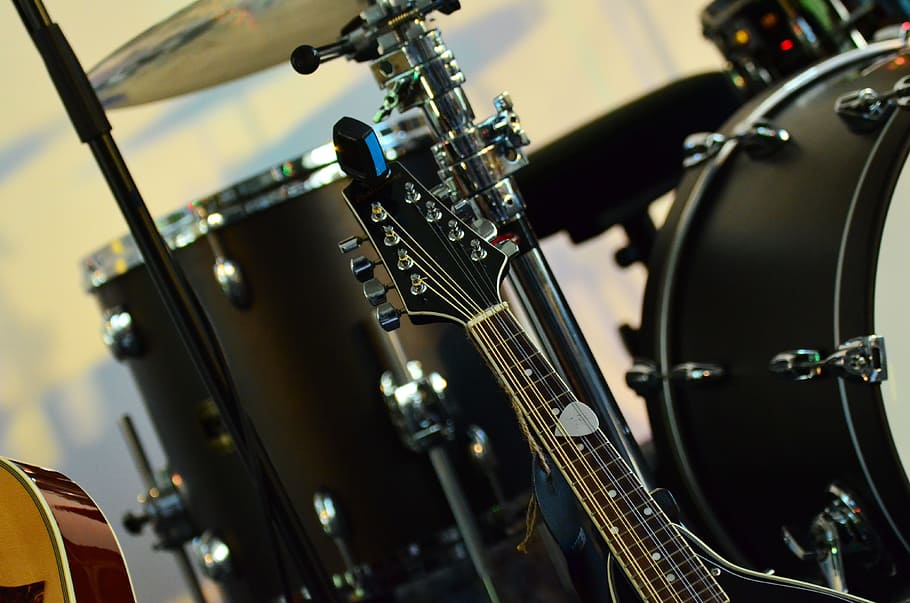 photo of black guitar beside drum set, instruments, music, drums