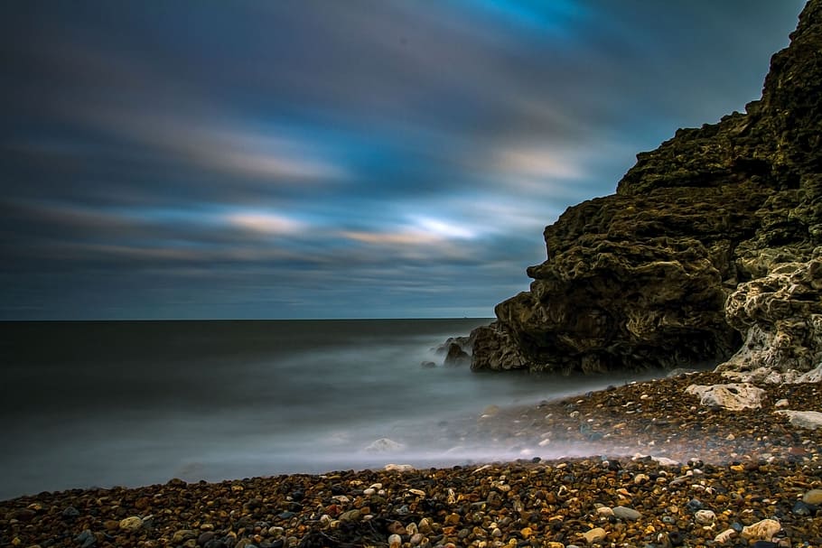 black rock formation over body of water during twilight, beach HD wallpaper