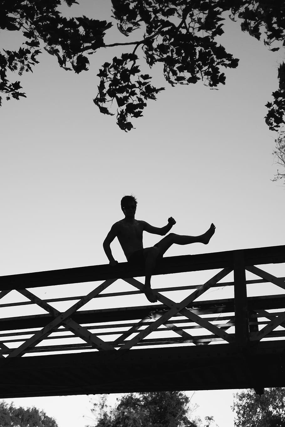 silhouette photo of a man about to jump on footbridge, silhouette of person sitting on bridge under white clouds, HD wallpaper