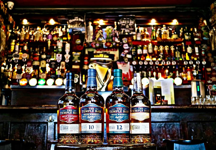 four whiskey bottles in bar counter, close up photo of four The Temple Bar liquor bottles HD wallpaper