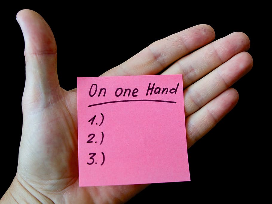 person holding pink sticky note, hand, list, embassy, message