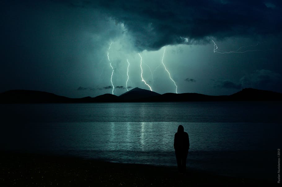person standing near seashore and mountain cliff with thunder, HD wallpaper