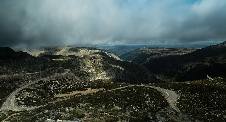 mountain ranges, aerial photography of mountains and roads under cloudy sky HD wallpaper