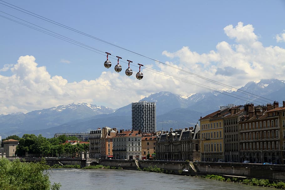 cable car near buildings above body of water, grenoble, city
