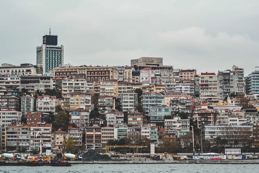 assorted-color buildings near body of water, white and brown skyscrapers HD wallpaper