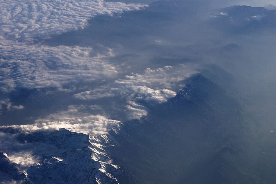 gray mountain on bird's eye view, high angle photography of mountain below clouds HD wallpaper