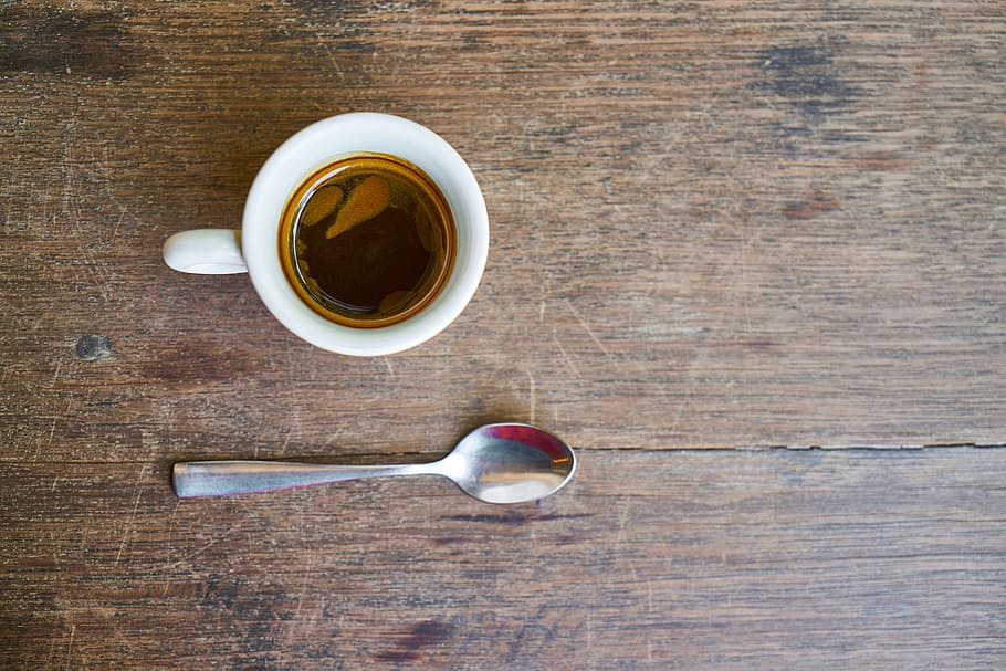 white ceramic teacup and gray spoon on brown wooden surface HD wallpaper