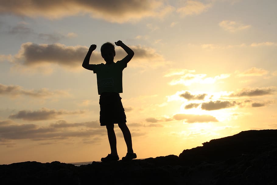 silhouette photo of boy on top of hill during daytime, life, beauty