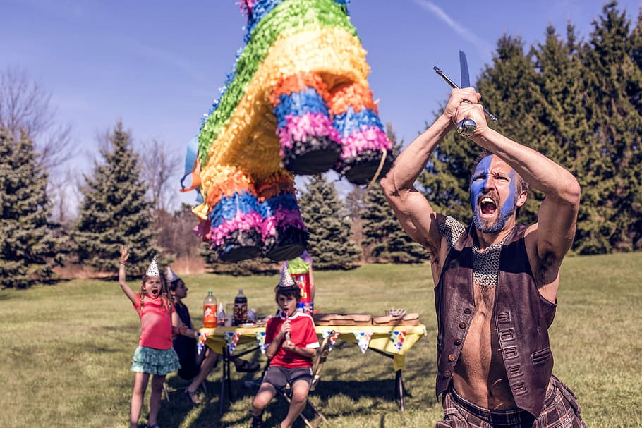 image contain man batting pinata, people, whimsical, lazy, party