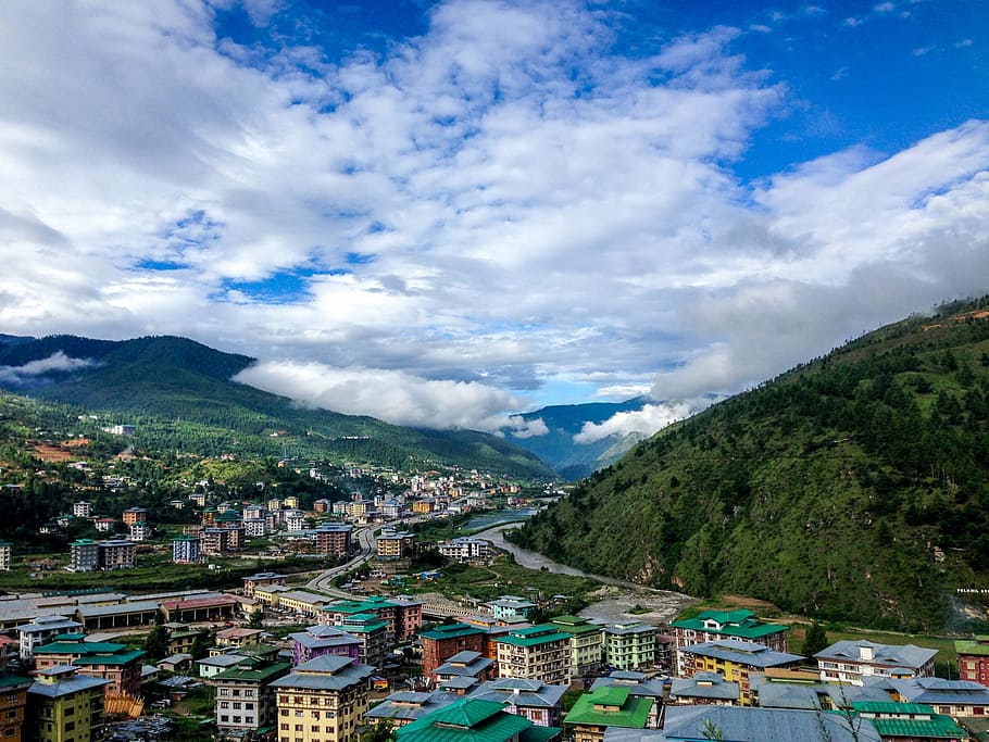 aerial view of city near mountain during daytime, bhutan, the village