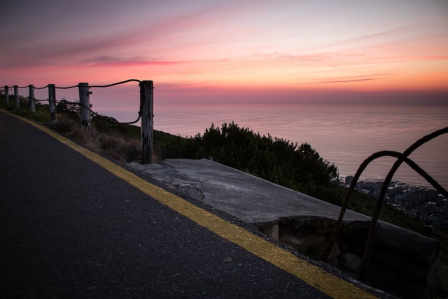 gray asphalt road near sea at golden hour, sidewalks, sunset HD wallpaper