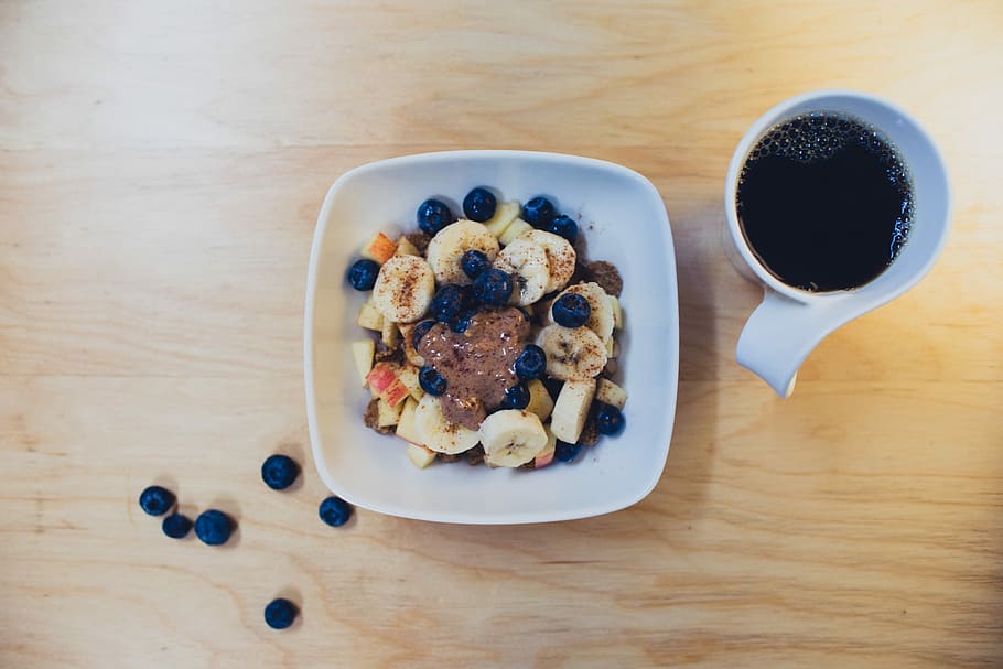 sliced bananas with berries and peanut butter beside cup of coffee on table, flat lay photography of pastry on plate HD wallpaper