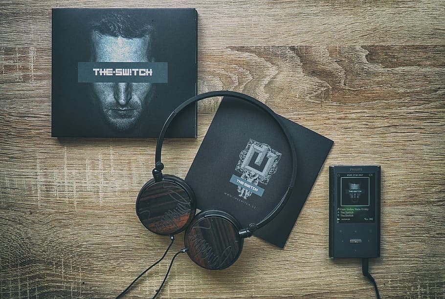 flat lay photography of Android smartphone, headphones, and The Switch box HD wallpaper