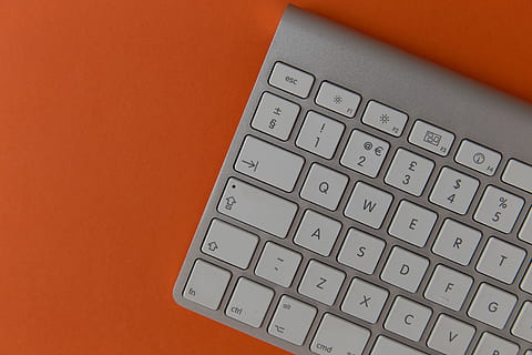 Apple wireless computer keyboard on orange background, technology HD wallpaper