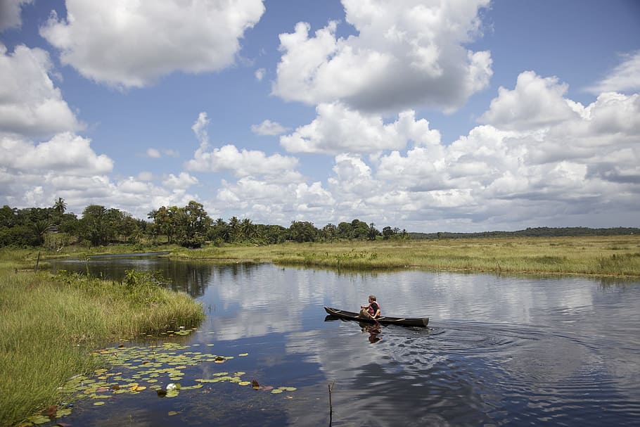person riding on canoe on lake, guyana, sky, clouds, stream HD wallpaper