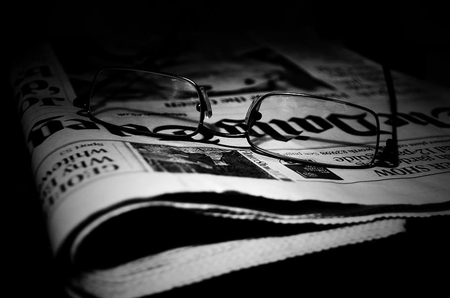 black framed eyeglasses on top of newspaper, article, background