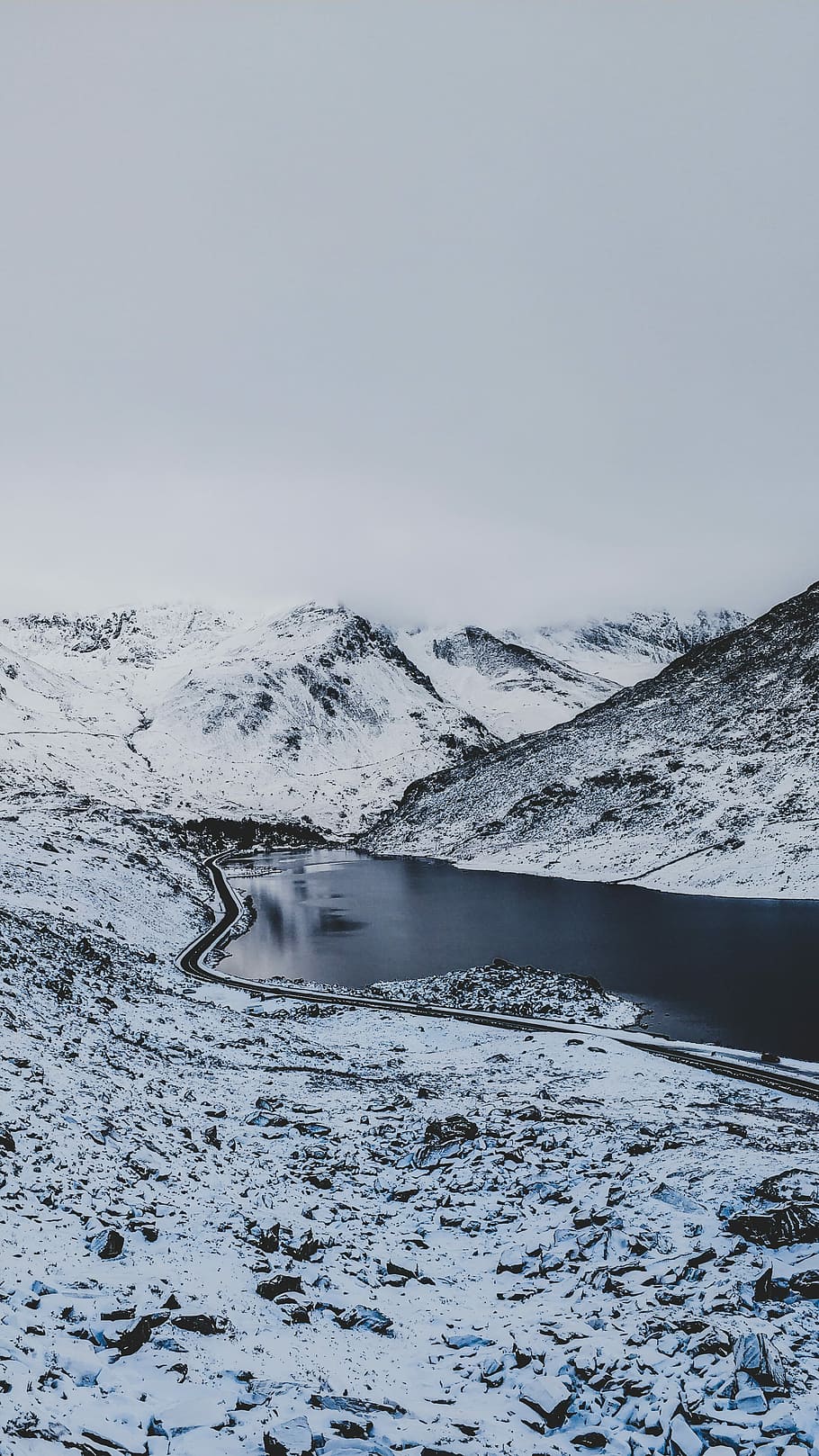 body of water between mountain, grayscale photography of river surrounded of valley HD wallpaper