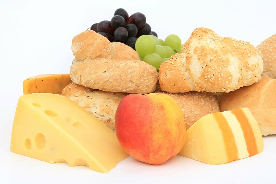 close-up photography of baked breads, cheese, grapes, and peach HD wallpaper